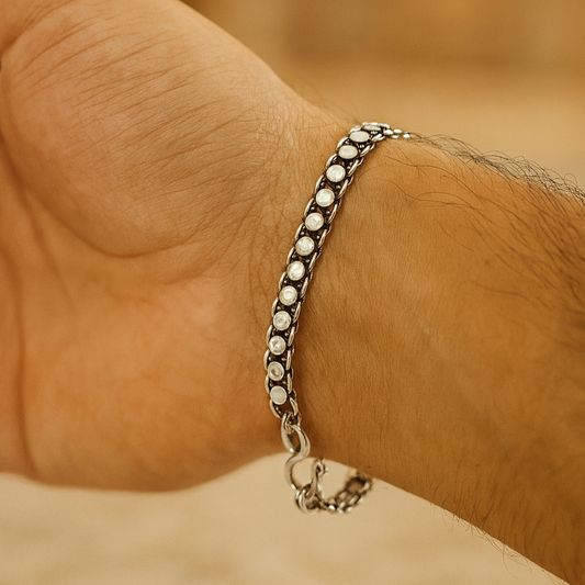 Silver bracelet on a wrist with a blurred background