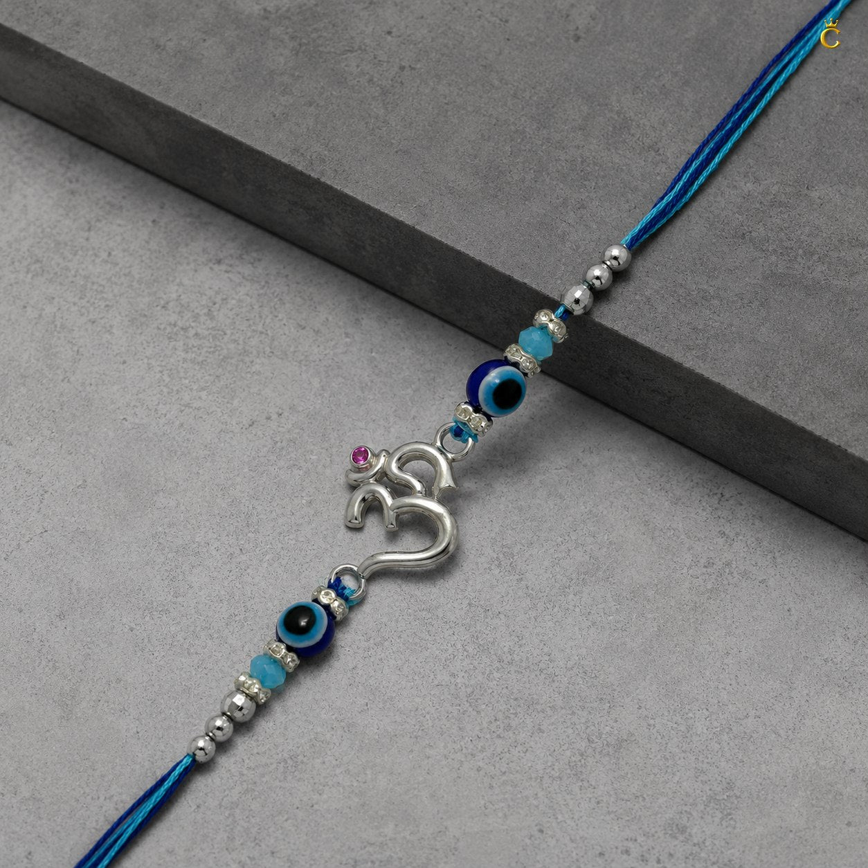 Celestora- Silver Om Evil Eye Premium Rakhi/ Bracelet